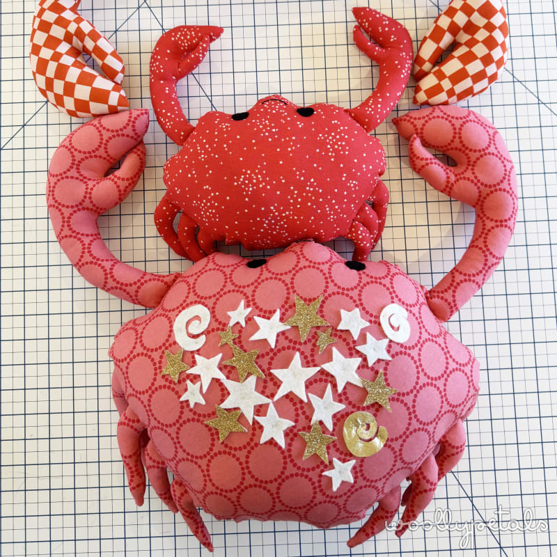 Woollypetals Coco the Crab stuffed animal in red and pink fabrics with checkered ears